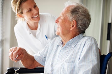 Caregiver helping elderly patient